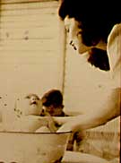 Randy in a basin 1947 in Batangas, Philippines with mom Helen Limjoco